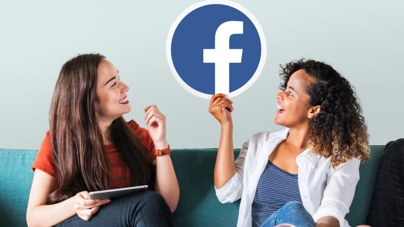 women showing a Facebook icon